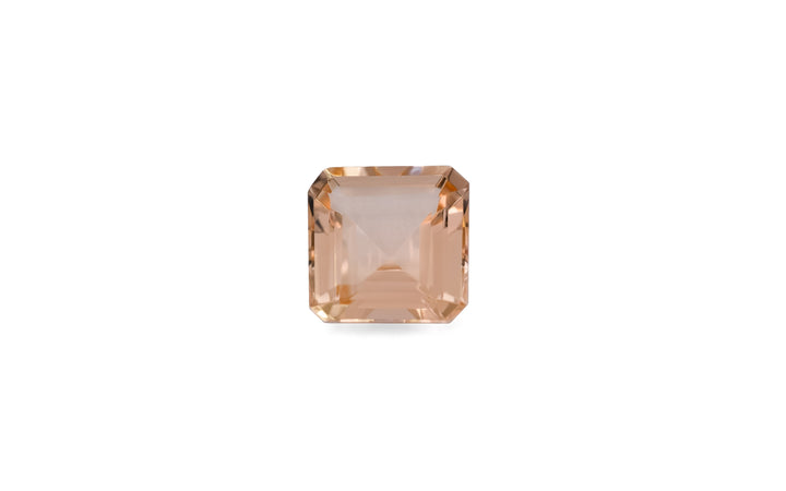 A square emerald cut peach morganite gemstone is displayed on a white background. 