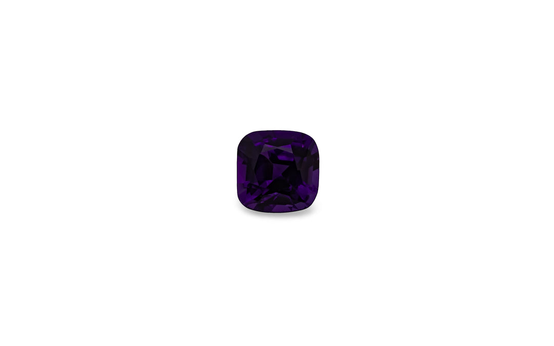 A square cushion cut purple Ceylon sapphire gemstone is displayed on a white background.