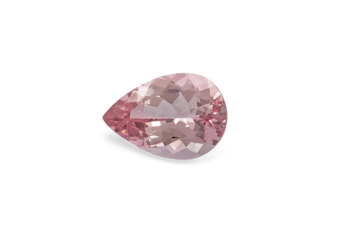 Pear cut pale pink morganite gemstone on a white background.