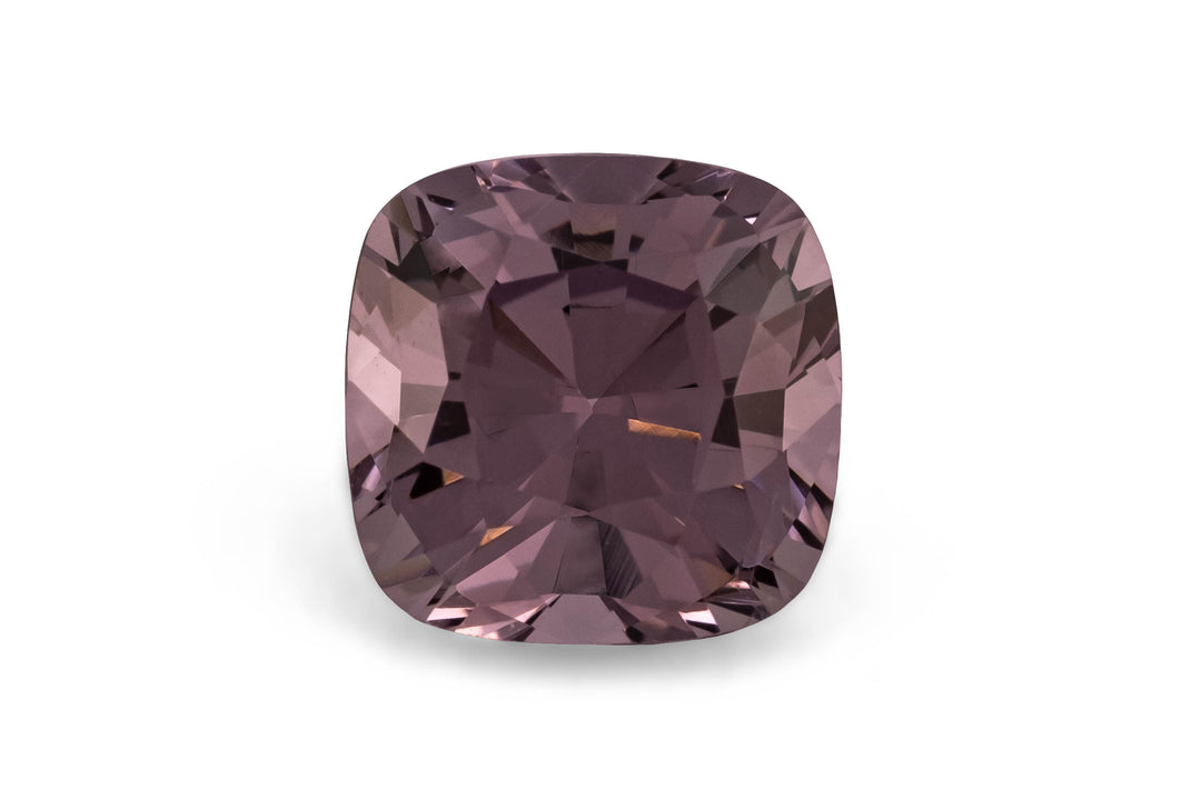 Square cushion cut purple spinel gemstone on a white background.
