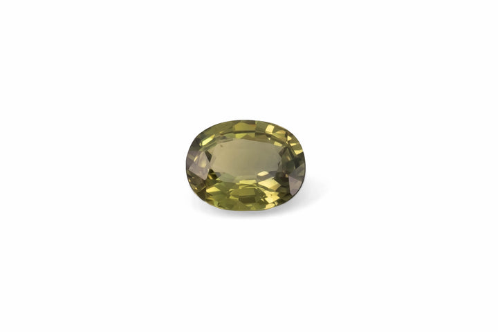An oval cut olive green Australian sapphire gemstone is displayed on a white background.